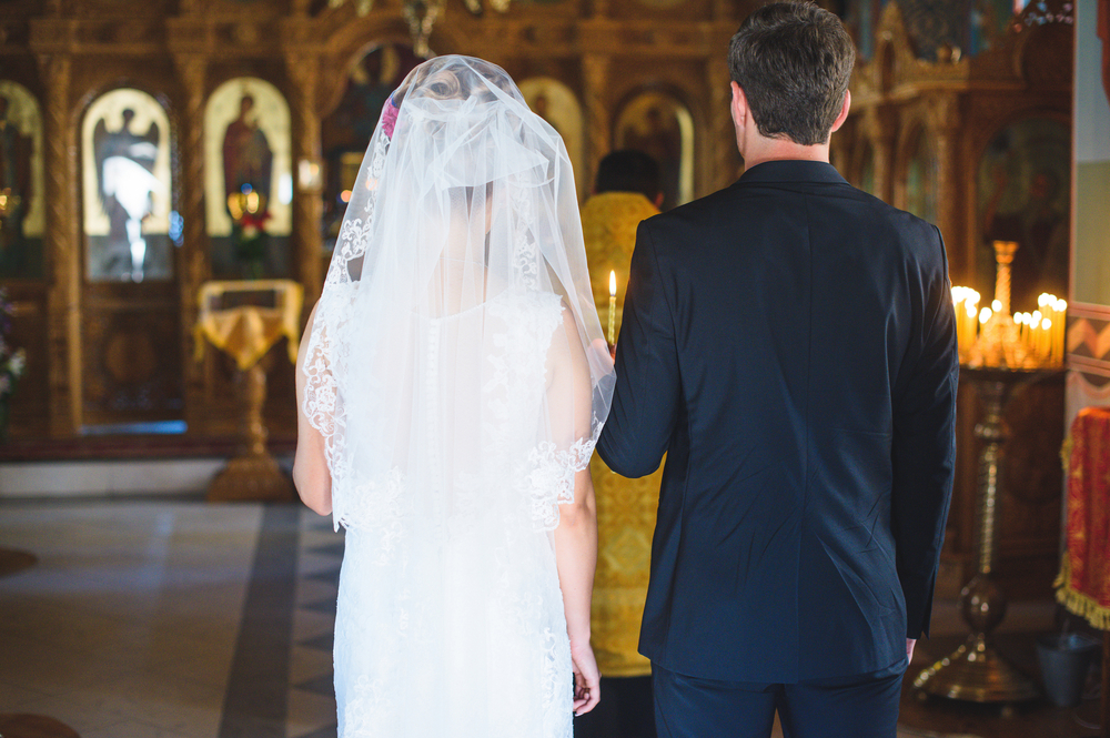 Couple,With,Candles,At,Wedding,Church